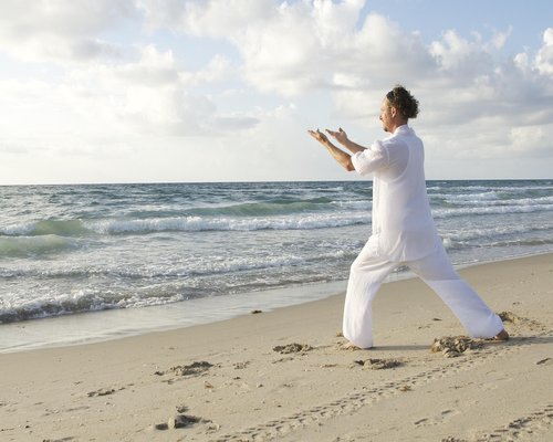Man practicing yoga and mindfulness outdoors in a park